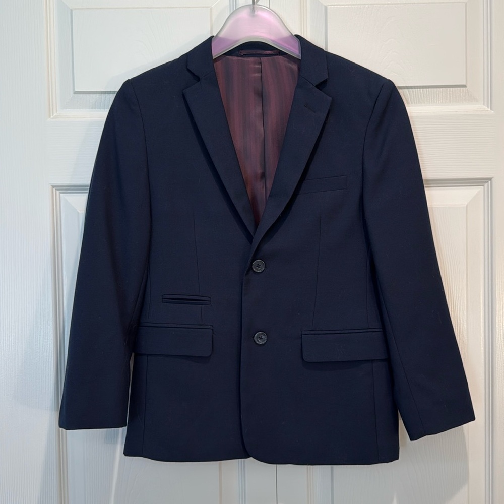 Two piece suit, side vents at jacket back, pants with hook and button closure.